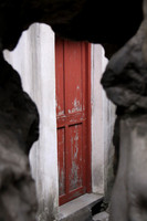 Red door through the rock window